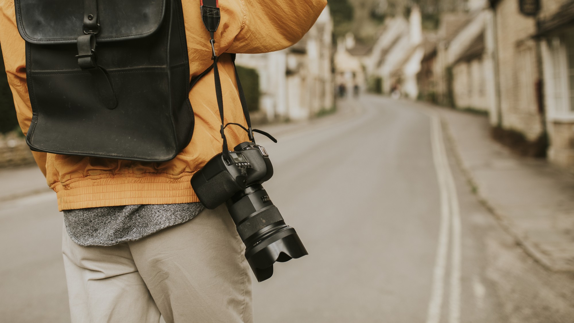 photographer-holding-a-camera-on-his-shoulder