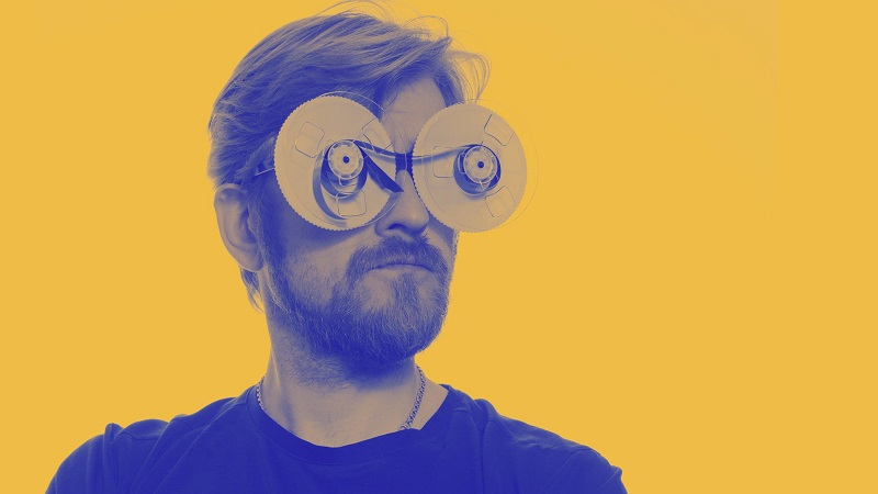 portrait-man-with-glasses-tape-reels-film portrait-man-with-glasses-tape-reels-film