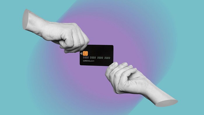 black-plastic-credit-card-is-hands-two-women-holding-it-from-different-sides-modern-design