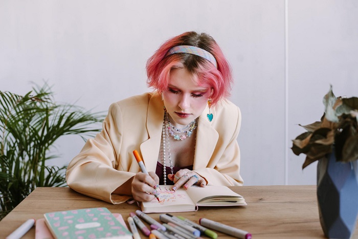 graphic-designer-girl-pink-hair-color-sketching-at-table